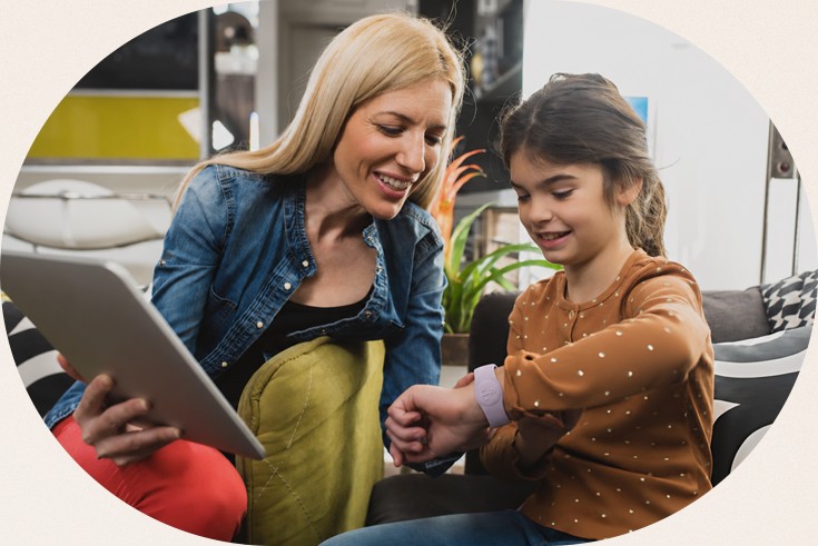 Mother and daughter on the couch with a tablet