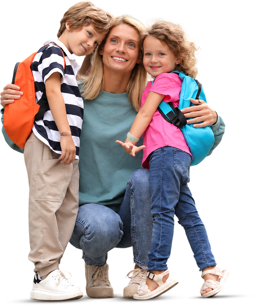 A mother kneeling with her two children, all smiling
