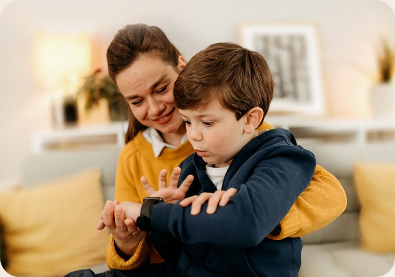 Mother and son looking at a bracelet together